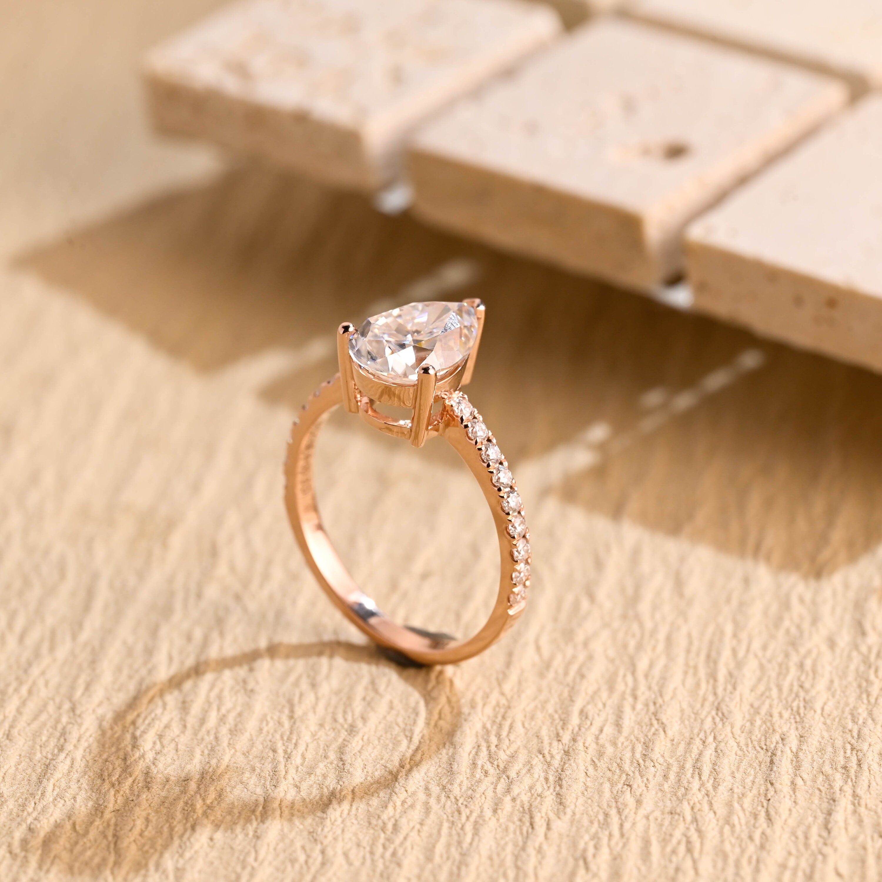 halo alternative pear pavé moissanite ring