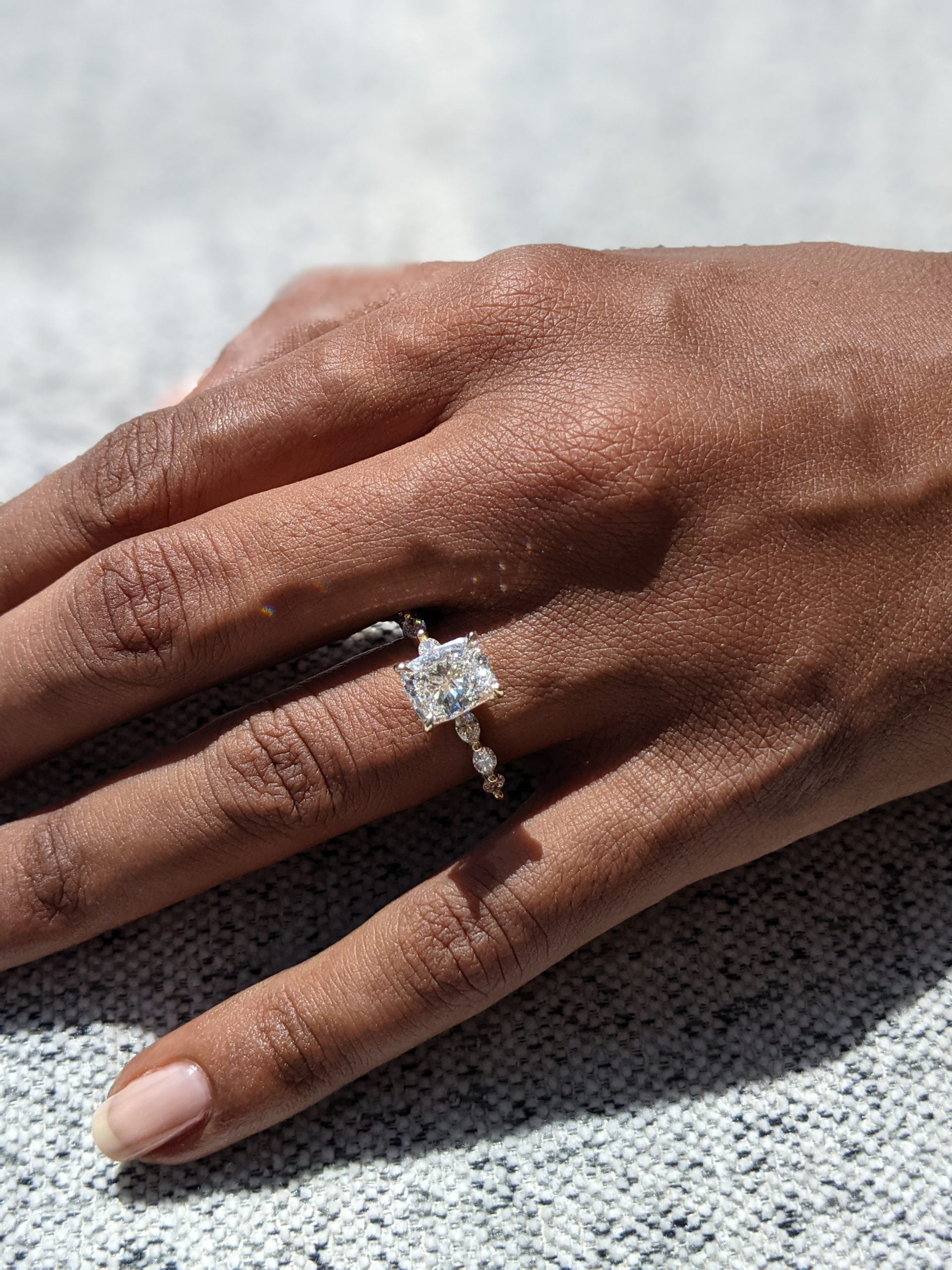 Elongated Cushion Engagement Ring Featuring a Pave Diamond Setting