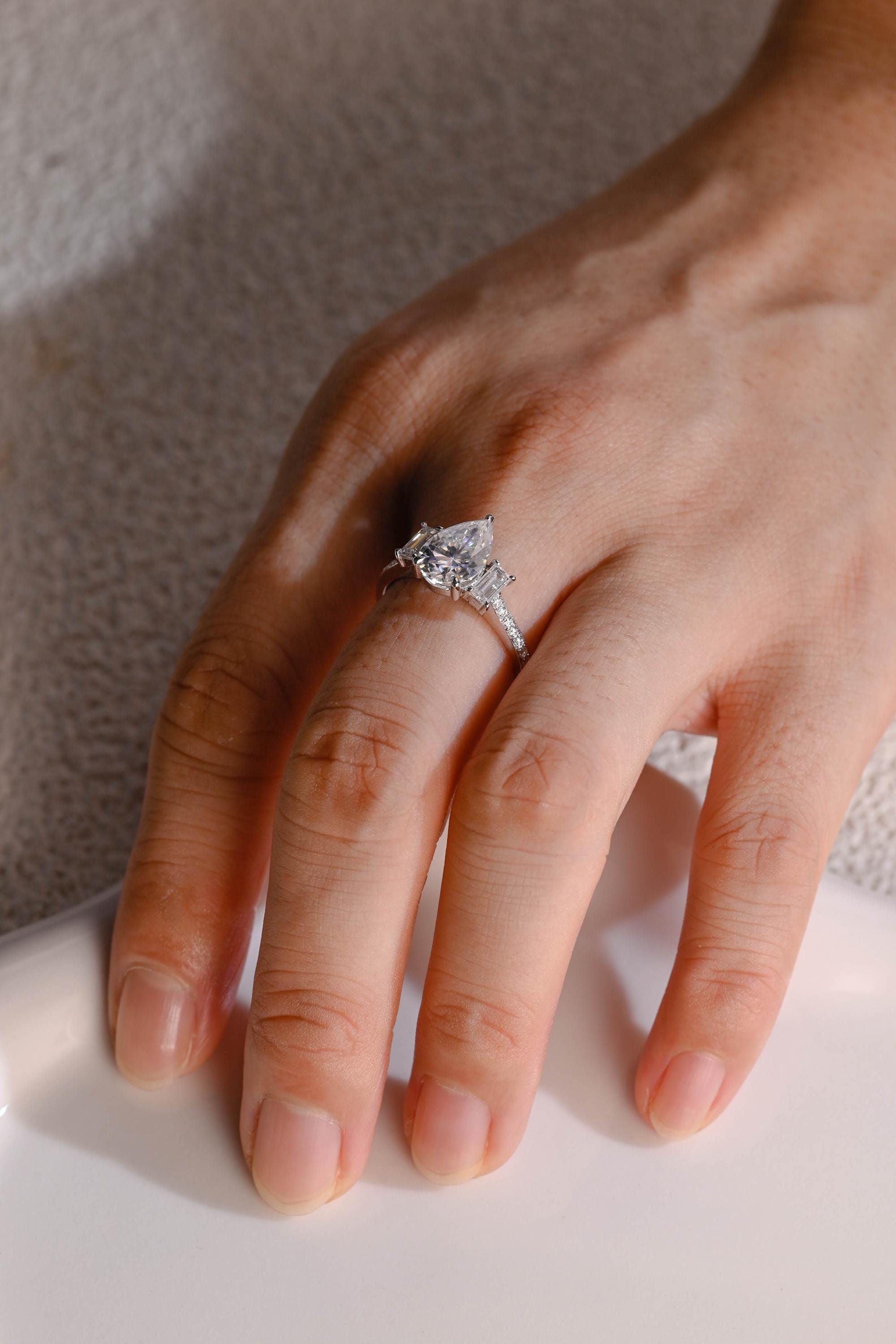 gold pavé three stone pear moissanite engagement ring