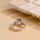 modern emerald cut bezel cluster engagement ring moissanite