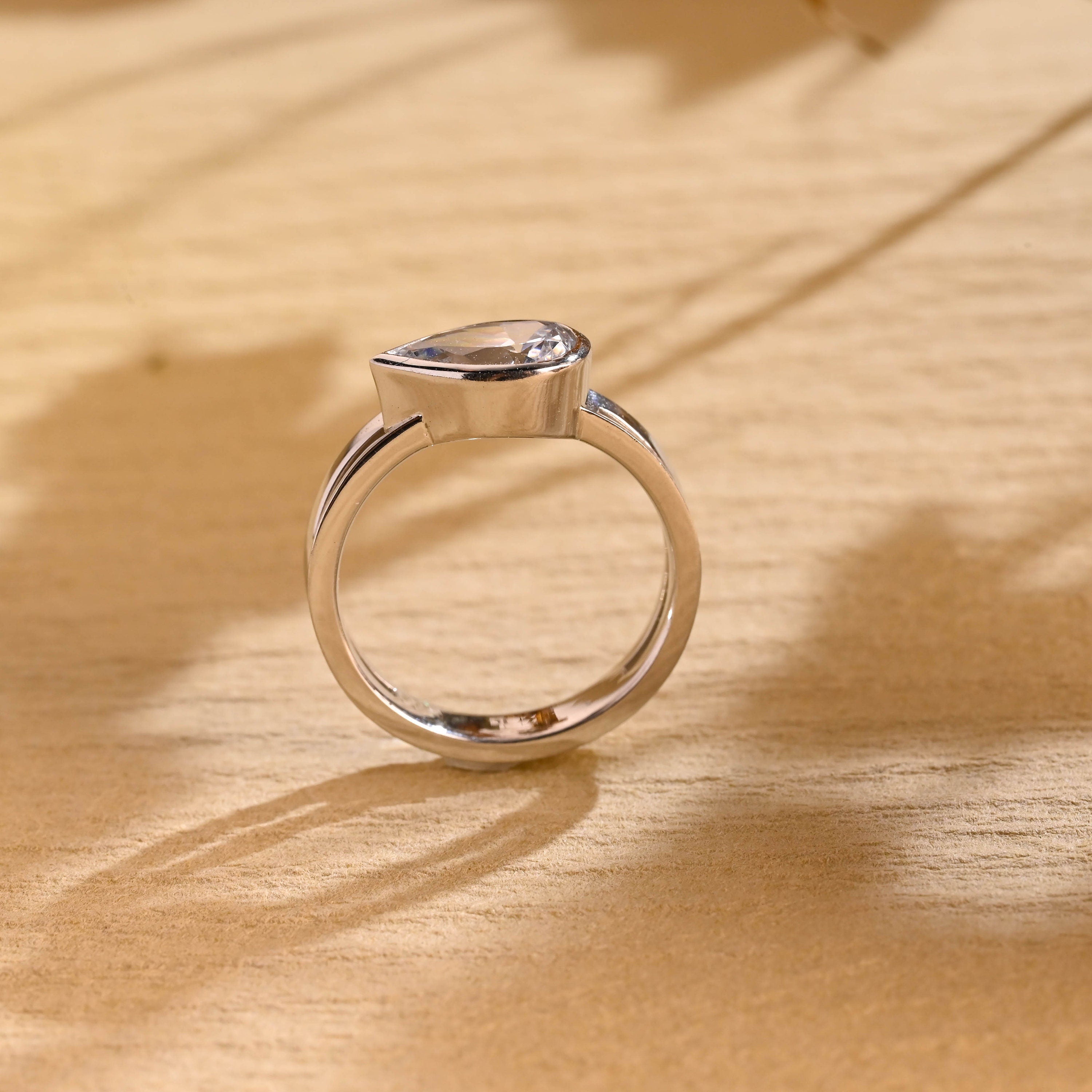 sustainable pear bezel engagement ring moissanite