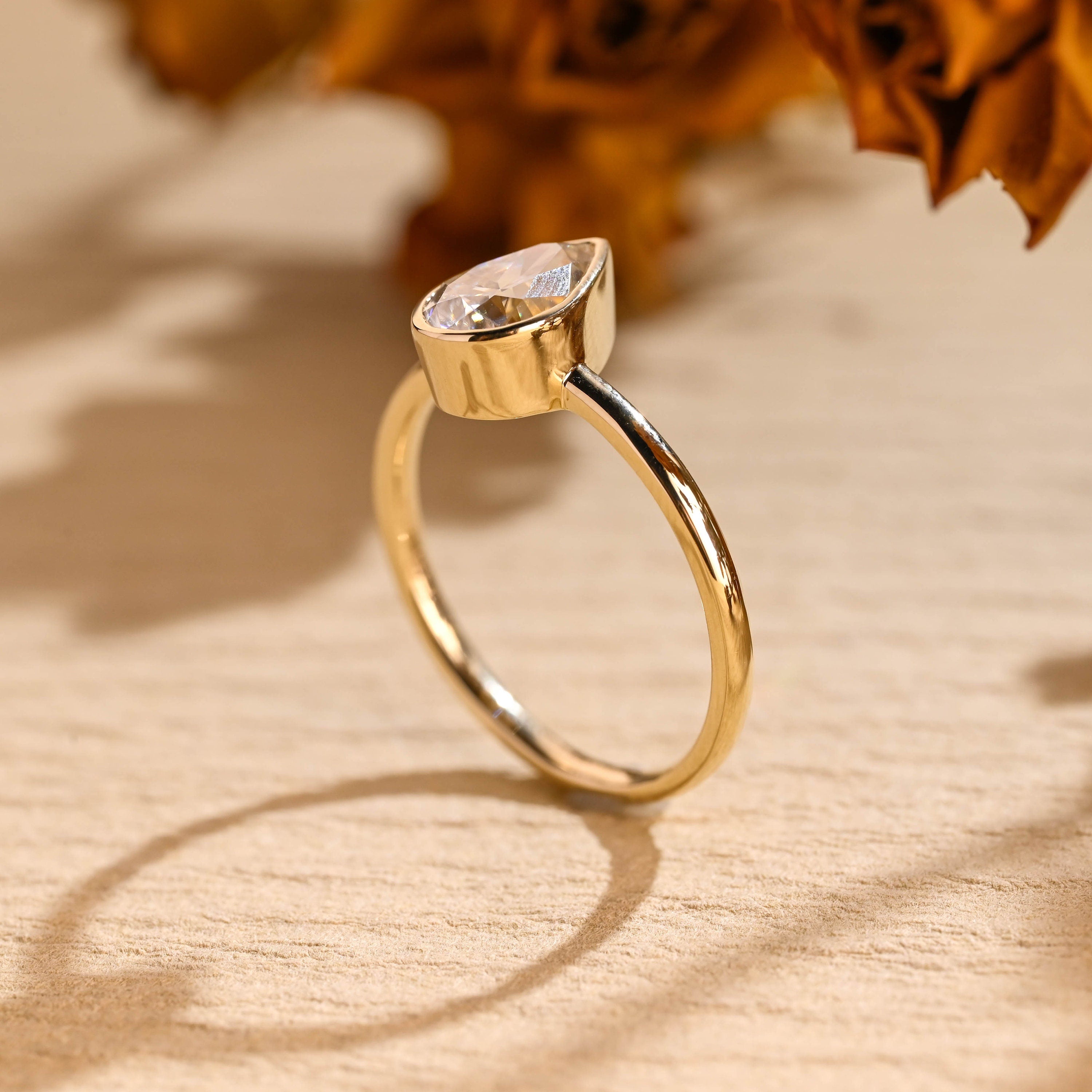 modern pear bezel solitaire engagement ring moissanite
