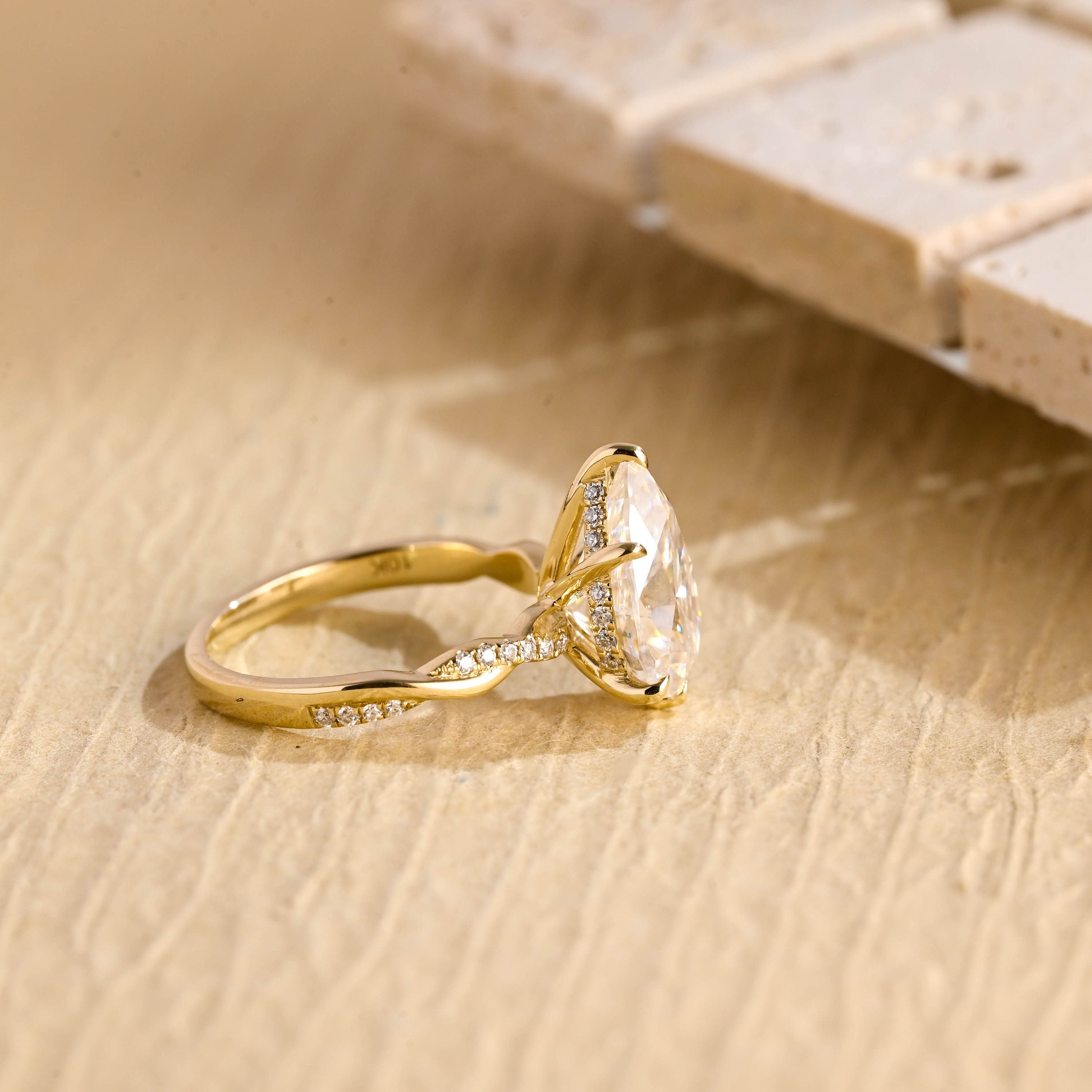 twisted band pear engagement ring moissanite