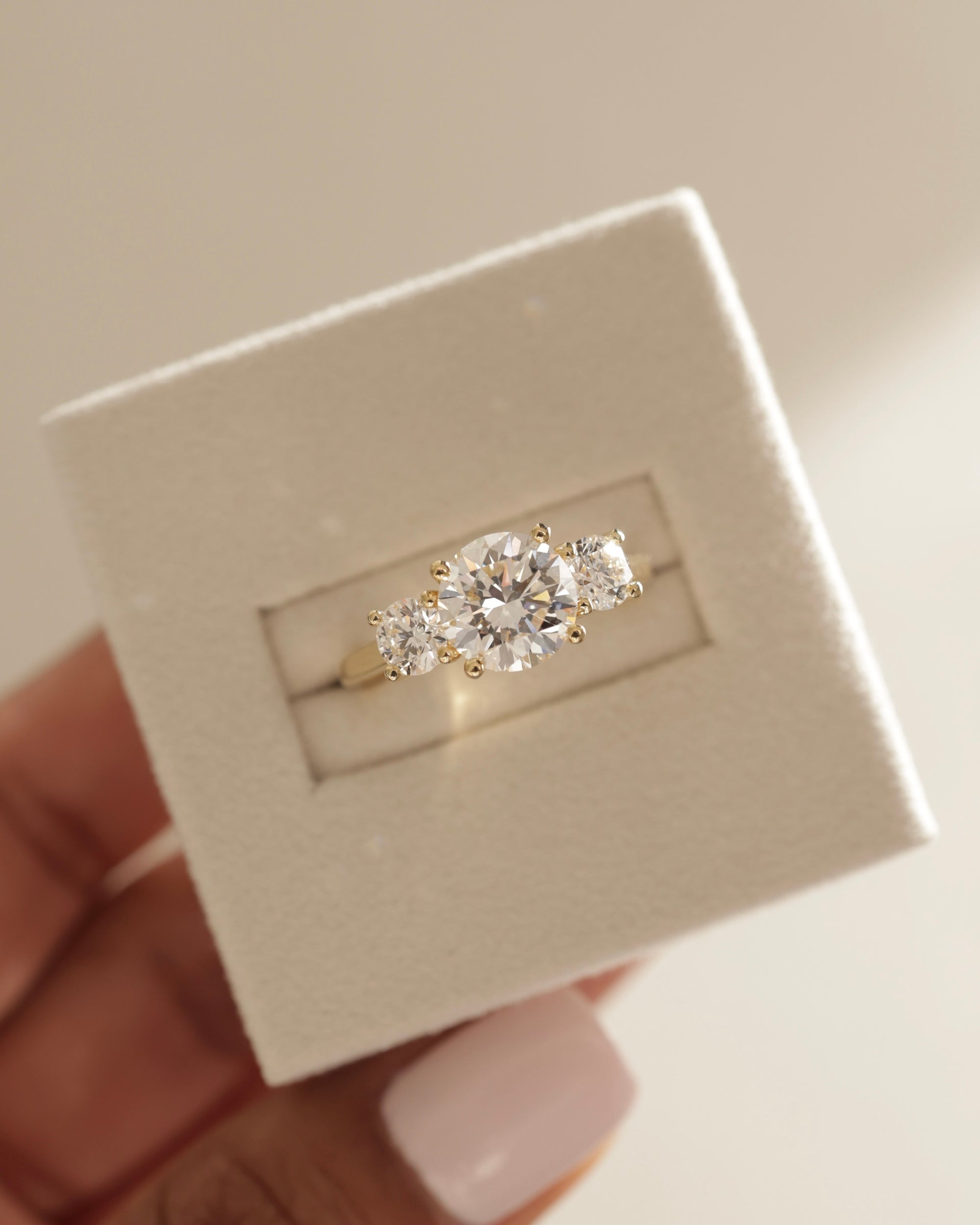 round moissanite trilogy ring, modern three stone ring, brilliant moissanite engagement band, luxury moissanite ring, sentimental three stone ring design